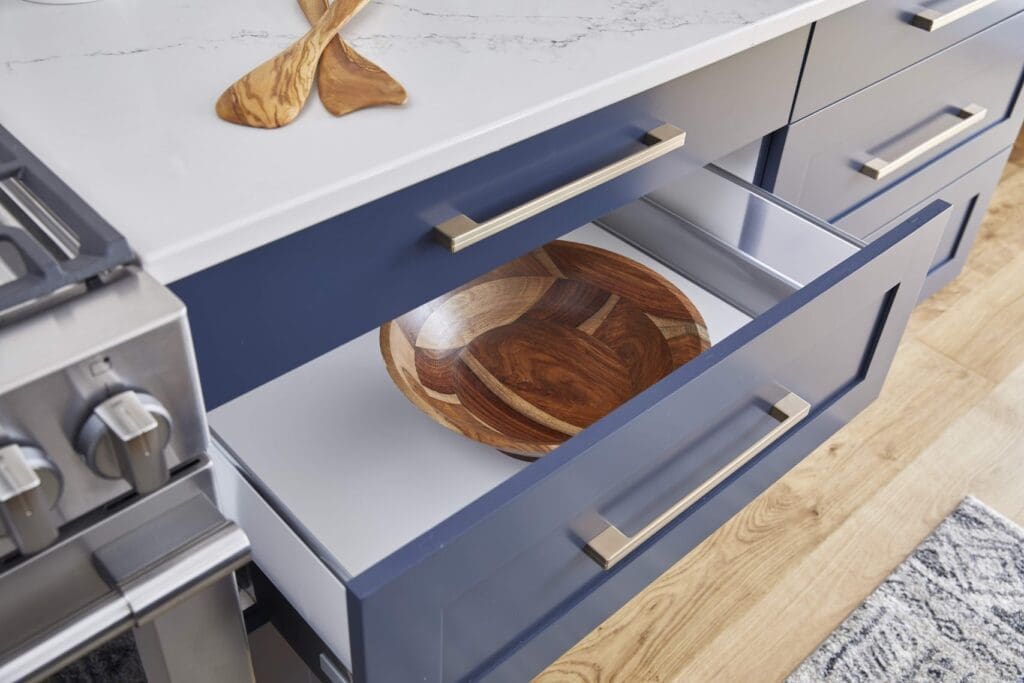 Blue kitchen cabinet drawer with bowl inside