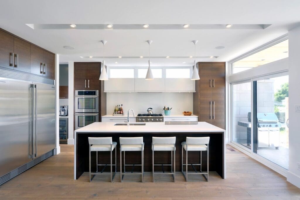 Brown cabinets with large waterfall countertop island