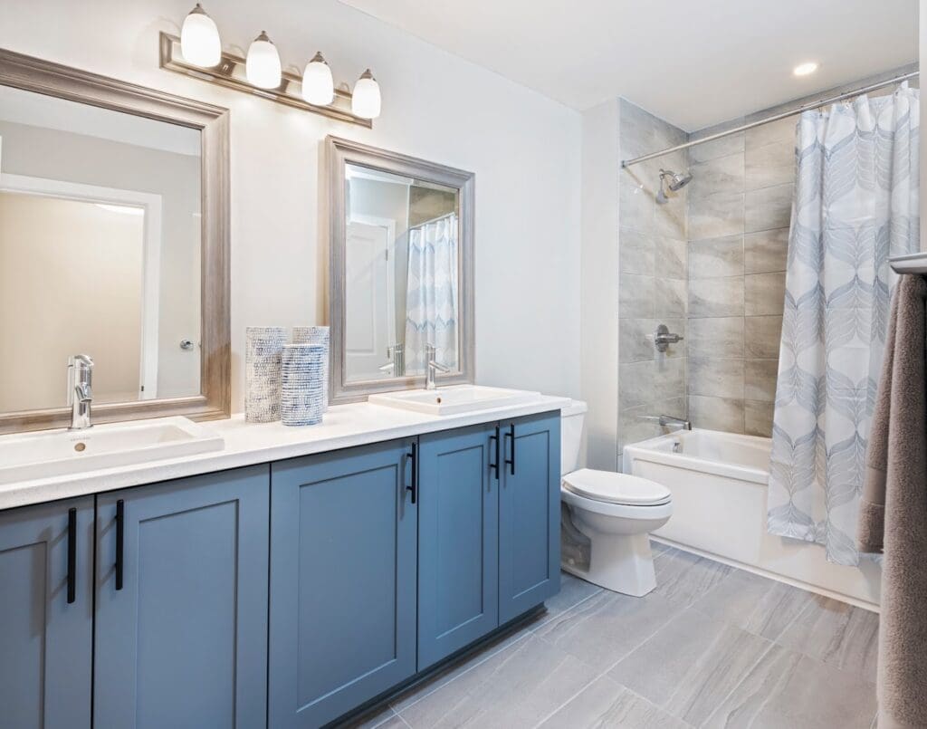 Double sink vanity with blueish grey cabinets