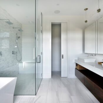 large glass wall shower and vanity in bathroom